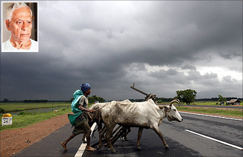 A farmer and his bullocks cross a highway against the backdrop of monsoon clouds in Singur. (Inset) Rabindranath Bhattacharya.