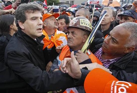 France's Minister for Industrial Recovery Arnaud Montebourg (L) talks to ArcelorMittal workers from Florange after a meeting with trade union representatives at the town hall in Florange, Eastern France