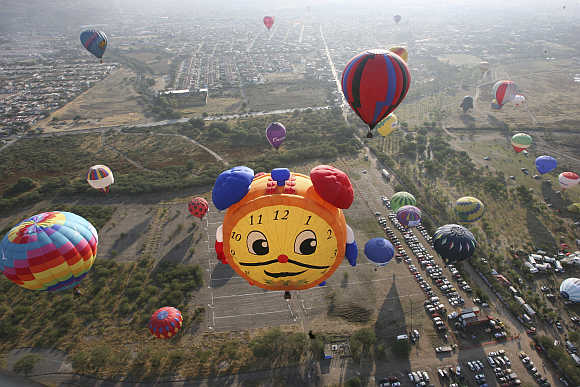 Hot-air balloons fly over the Metropolitano park during the International Hot-Air Balloon Festival in Leon in the Mexican state of Guanajuato.