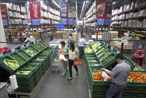Customers shop at a Best Price Modern Wholesale store, a joint venture of Wal-Mart Stores Inc and Bharti Enterprises, at Zirakpur, Punjab.