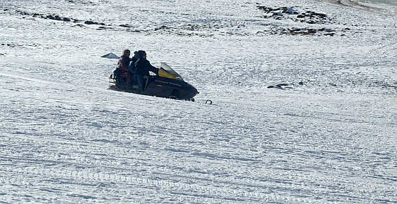 Tourists enjoy a ride on a snowmobile in Himachal Pradesh.