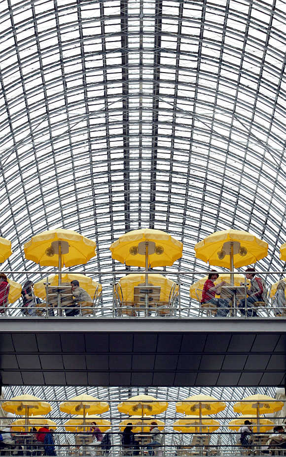 Visitors sit at a cafe under the glass roof of Moscow's GUM superstore.