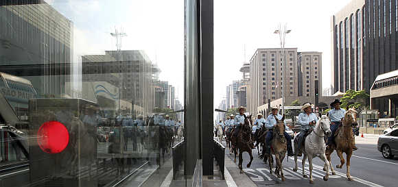 People ride horses along a main avenue in the financial centre of Sao Paulo during World Car Free Day.