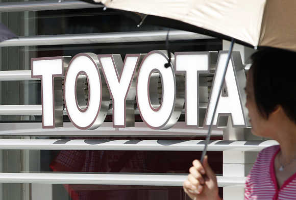 A woman walks out from a Toyoto Motor Corp showroom in Tokyo.