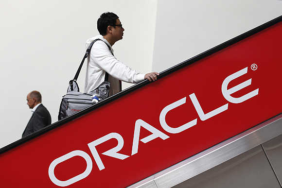 Two attendees ride an escalator during Oracle OpenWorld 2012 in San Francisco.