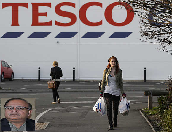 Devashish Mitra, inset. A shopper leaves a Tesco store in Loughborough, central England.