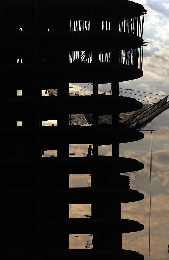 A man stands in a building under construction in Mumbai.