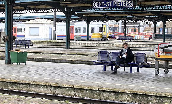 A passenger waits on a platform at Saint Pieters railway station in Ghent, Belgium.
