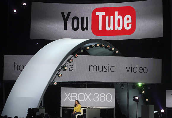 A woman demonstrates YouTube services on the Xbox game console in Los Angeles.