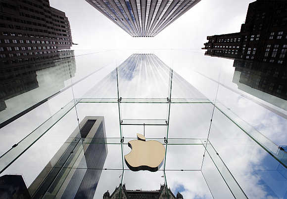 Apple logo hangs in a glass enclosure above the Fifth Ave Apple Store in New York.