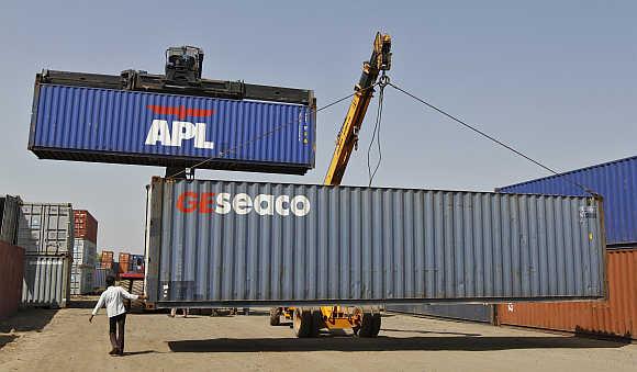 Mobile cranes prepare to stack containers at Thar Dry Port in Sanand, Gujarat.