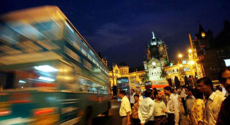 A bus speeds past Chhatrapati Shivaji Terminus in Mumbai