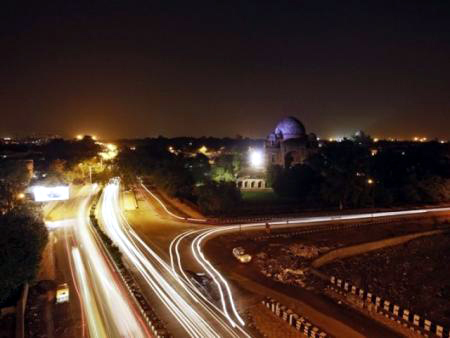 Traffic moves along a busy road in New Delhi