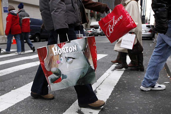 Shoppers carry bags as they walk down Fifth Avenue in New York.