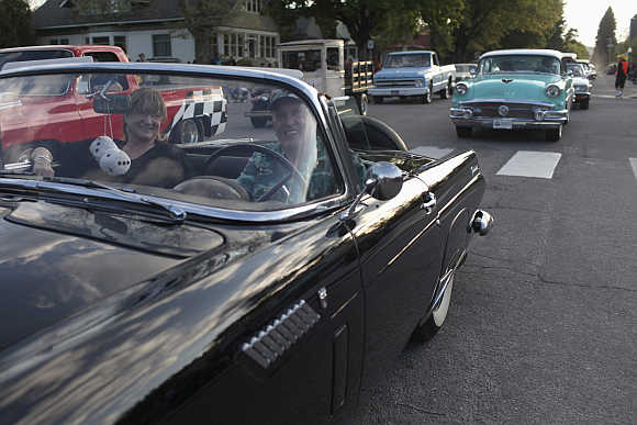Sandra and Jim Devine from Sagle, Idaho, drive their 1963 Dodge Dart along the 'Lost in the 50's' parade route in Sandpoint, Idaho.