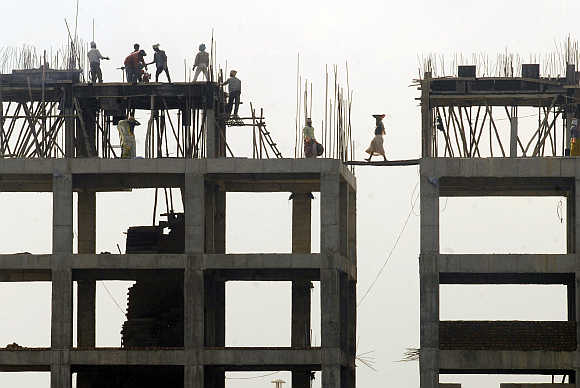 Labourers work at a construction site in Hyderabad.