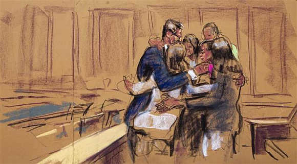 Rajat Gupta is seen hugging his family in this courtroom sketch, in New York.