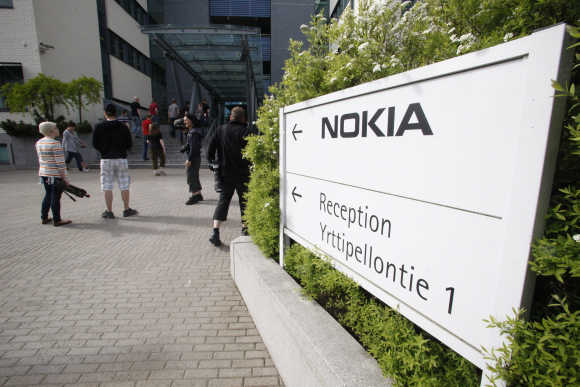 Nokia employees arrive for a personnel briefing in Oulu, Finland.