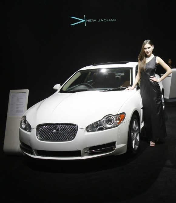 Investment has become tepid due to investor uncertainty, says Lahiri. A model poses with a Jaguar XF in New Delhi.