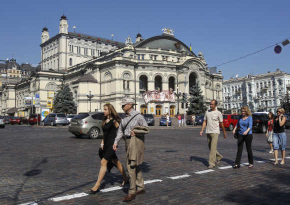People walk in front Kiev's Opera in downtown Kiev.