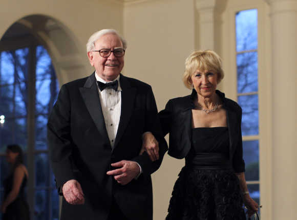 Warren Buffett and his wife Astrid Menks arrive for a State Dinner at the White House in Washington.
