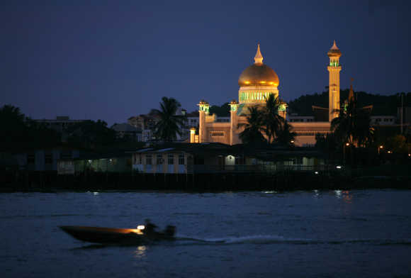 Water taxi passes landmark Sultan Omar Ali Saifuddien Mosque in Bandar Seri Begawan.