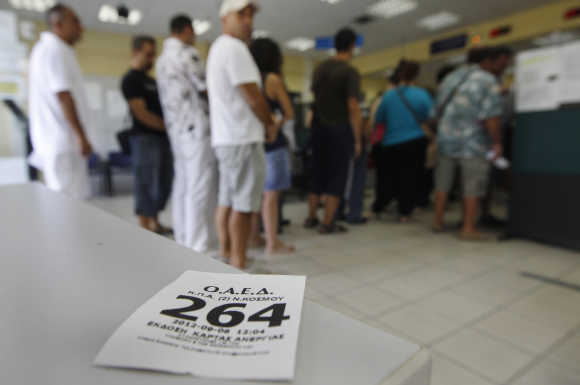 People line up inside an unemployment bureau in Athens, Greece.