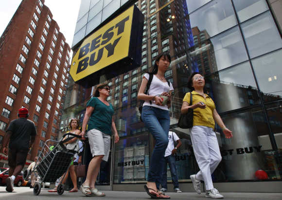 People walk past a Best Buy store in New York.