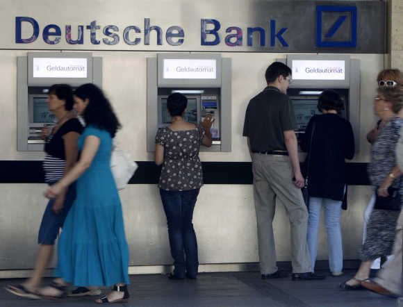 People use ATMs in Munich.
