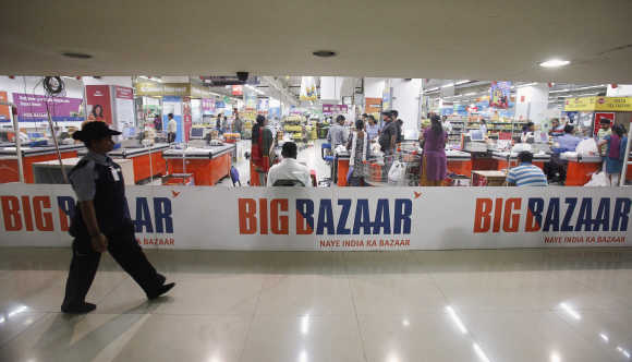 A security personnel walks past the Big Bazaar retail store in Mumbai.