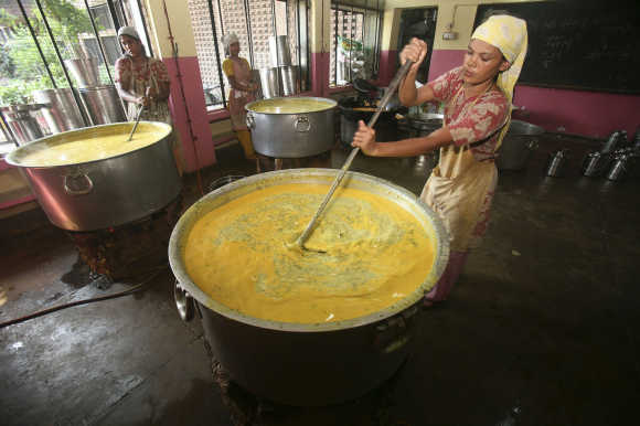 Workers prepare mid-day meal for schoolchildren at a school in Chandigarh.