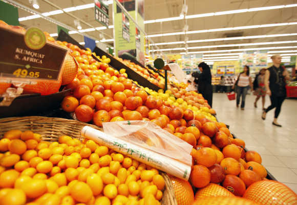 Customers shop near the fruits isle at Carrefour supermarket in Dubai.