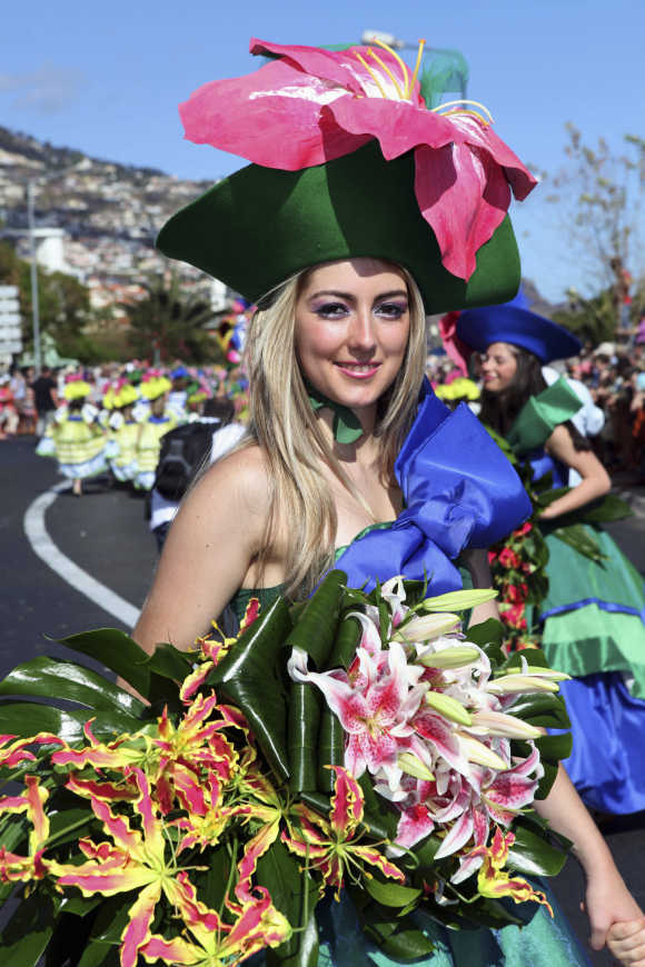 A girl smiles during a parade at Madeira Island Flowers Festival in Funchal, Portugal.