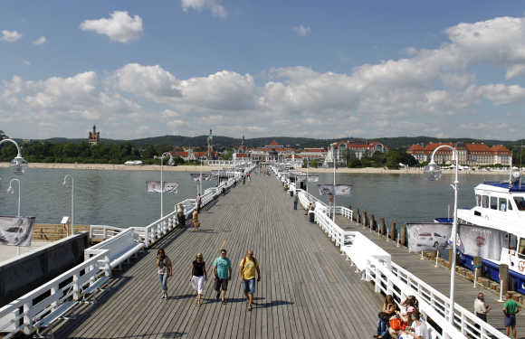 Tourists walk along Sopot pier in Gdansk, Poland.