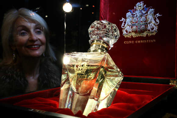 A woman looks at a bottle of 'Imperial Majesty' by Clive Christian, which costs $198,197 for 500ml, in the Roja Dove Haute Perfumerie in Harrods, Knightsbridge, London.