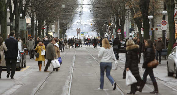 People walk on Zurich's main shopping street Bahnhofstrasse.