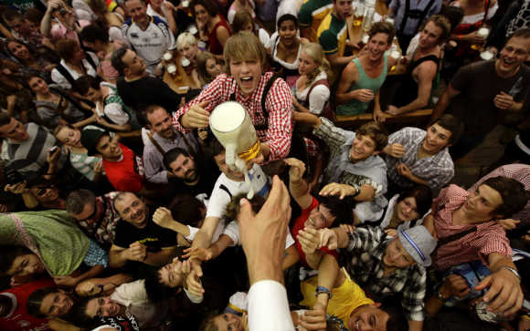 Revellers scuffle for the first free beer in the traditional one-litre beer mug at the opening of the World's biggest beer fest, the Munich Oktoberfest, at the Theresienwiese in Munich.