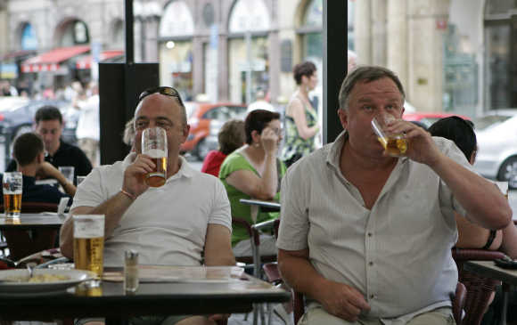 British tourists drink beer in central Prague.