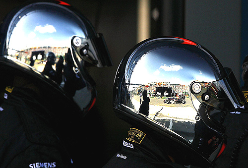 The pit lane is reflected in the chrome helmets of the McLaren Mercedes pit crew during qualifying for the Australian Formula One Grand Prix at the Albert Park Circuit on April 01, 2006 in Melbourne.