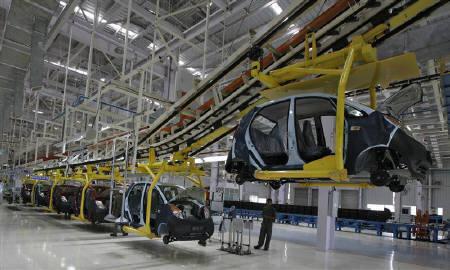 An employee stands inside the Tata Nano plant at Sanand in Gujarat