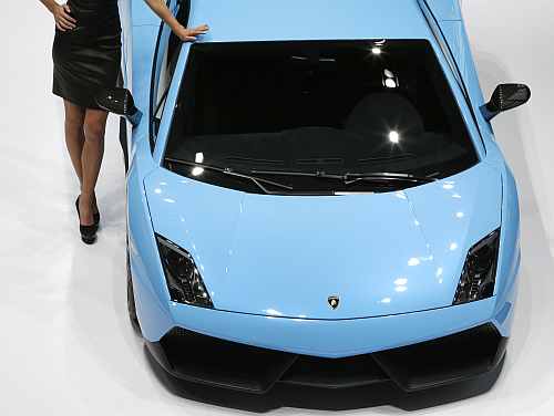A model poses next to a Lamborghini Gallardo LP570-4 Superleggara