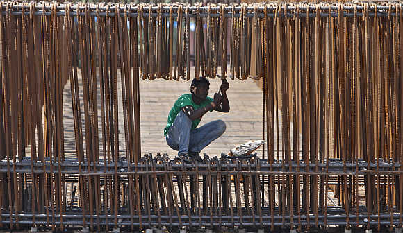 A labourer works at a construction site of a flyover in Ahmedabad.