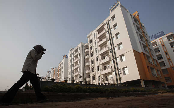 A labourer walks past residential apartments in Patna.