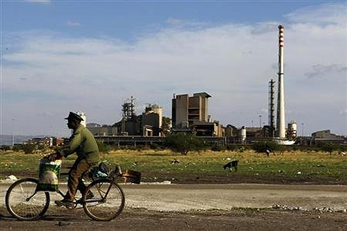 A man rides his bike past the Lonmin mine outside Rustenburg, in the northwest of Johannesburg.