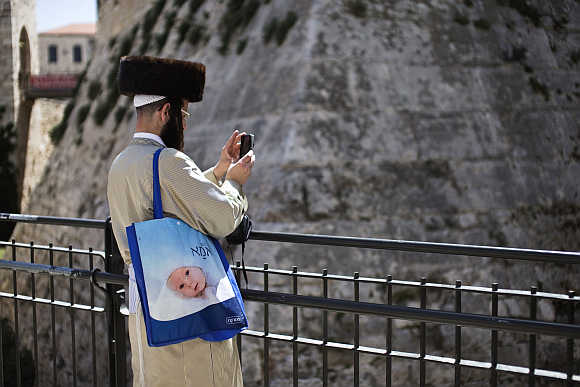 An ultra-Orthodox Jewish man uses his mobile phone to take a picture in Jerusalem's Old City.