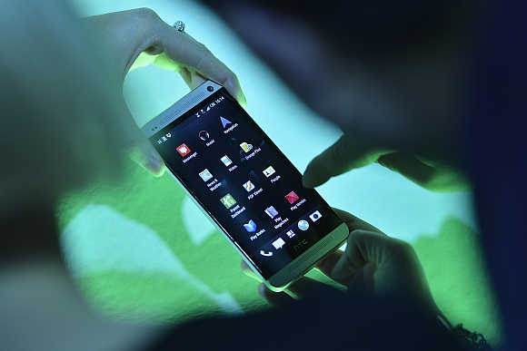 Guest uses a sample phone at the launch of the HTC One smartphone in London.