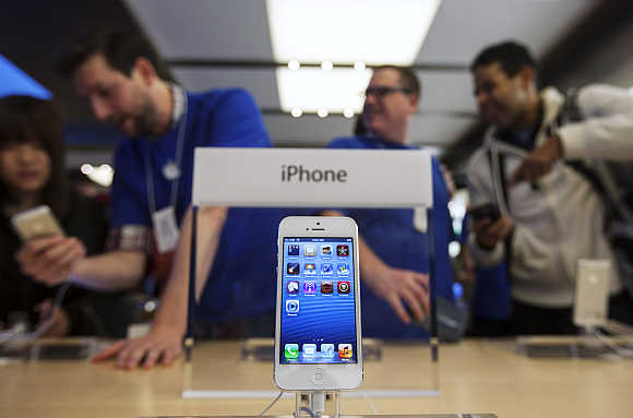 An iPhone 5 is displayed in the Apple Store on Fifth Avenue in New York.