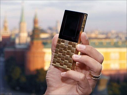 Mathias Rajani, Danish luxury product company Aesir's chief commercial officer, holds a model of his company's new mobile phone during a press presentation in Moscow.