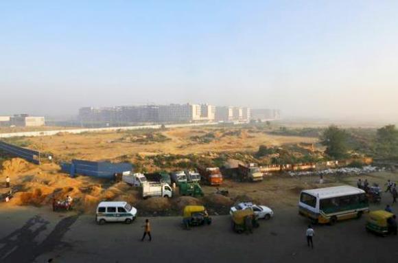 Traffic moves past hotels being constructed outside the Indira Gandhi International Airport in New Delhi.