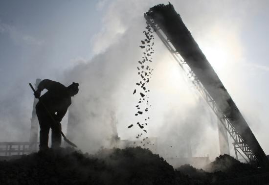 A Man works at a coal mine.